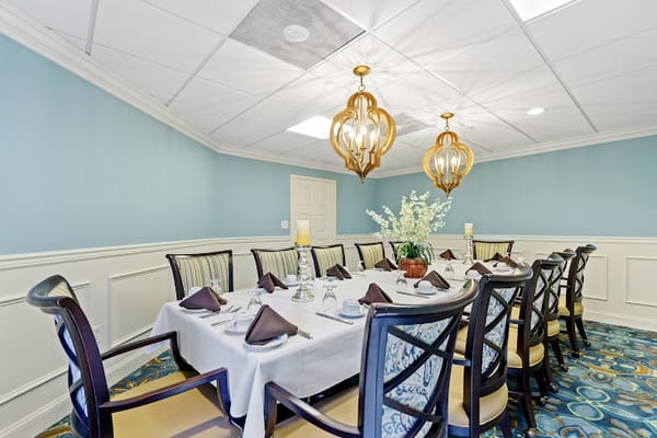 Elegant dining room set for a meal with floral centerpiece