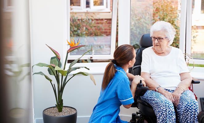 Caregiver interacting with a resident in a sunlit room