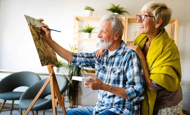 Seniors painting in a bright activity room