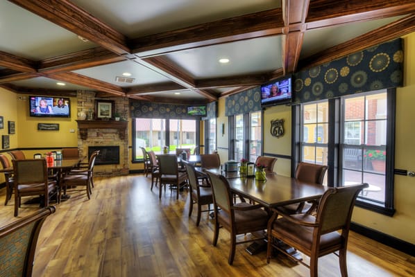 Dining area with tables and chairs in a sunny room