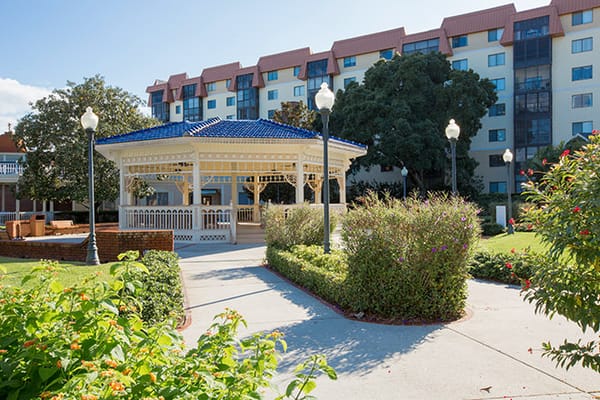 Beautiful outdoor gazebo surrounded by gardens and buildings
