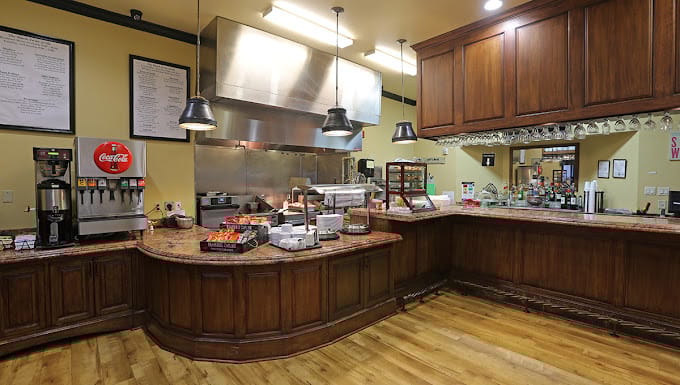Dining area with wooden counter and food displays