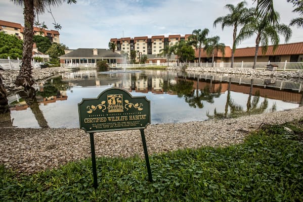 Pond and certified wildlife habitat sign near the facility