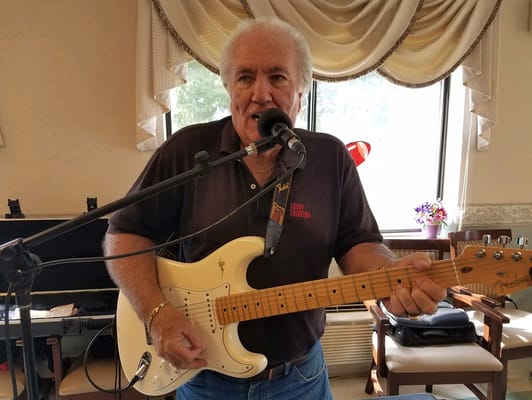 Resident performing music in a common area