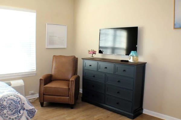 Cozy resident room with a chair and dresser