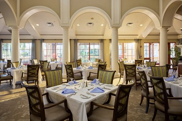 Dining area with elegantly set tables and natural light