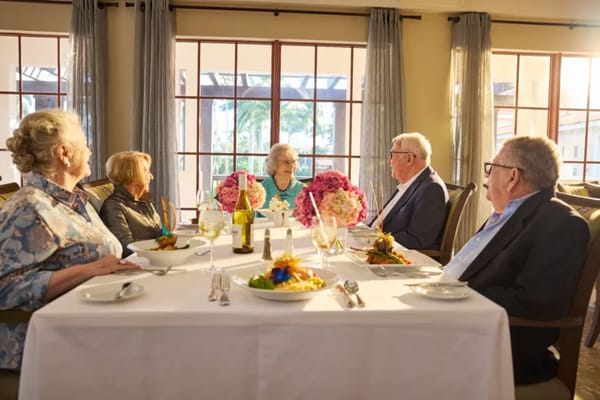 Residents enjoying a meal together in the dining room