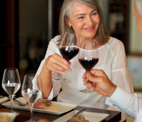 Residents enjoying a toast over a dinner table