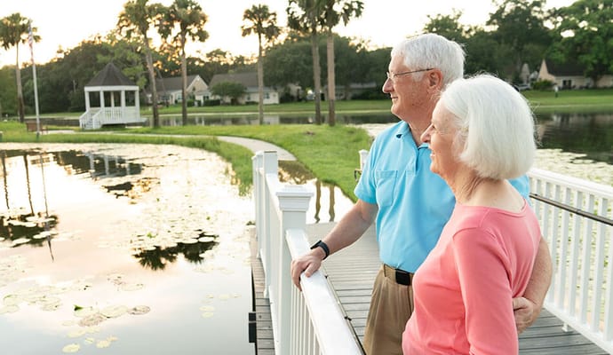 Couple enjoying a lakeside view at sunset