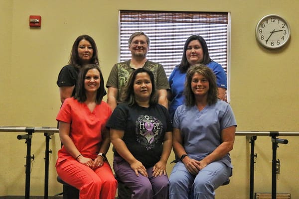 Staff members posing in a facility interior
