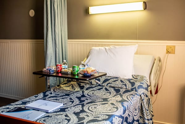 A well-prepared patient room with snacks on a table