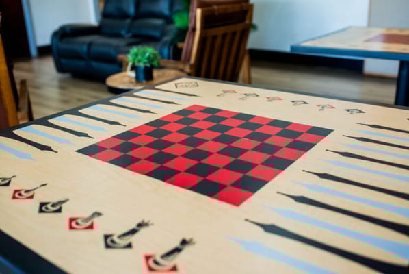 Close-up of a checkerboard table in a common area