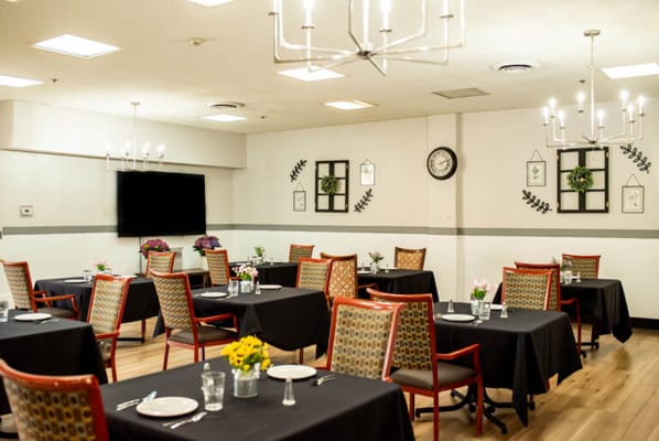 Bright dining room with tables set for meals