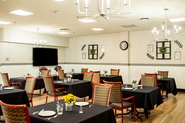 Bright dining room with tables set for meals