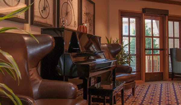 Interior view of a common area with a piano and seating