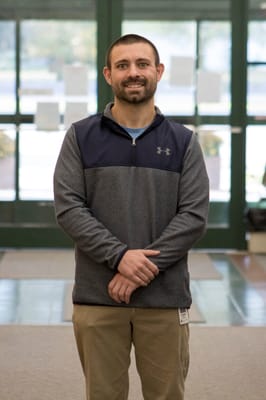 Staff member smiling in the facility lobby