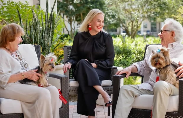 Residents and staff enjoying time outdoors with dogs