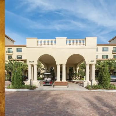 Exterior view of the facility entrance with palm trees