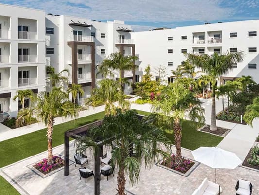 A serene courtyard with seating areas and palm trees