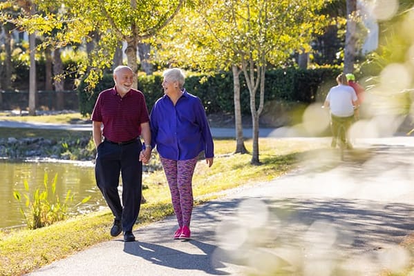 Seniors walking in a scenic outdoor pathway