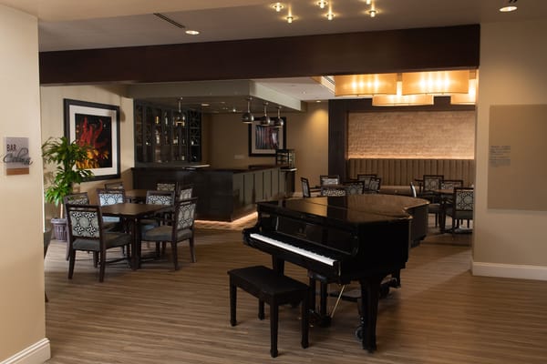 Interior of a dining area with a piano and seating