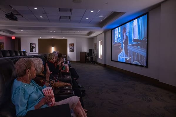 Residents enjoying a movie in the theater room