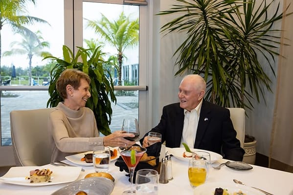 Two residents enjoying a meal together in the dining room