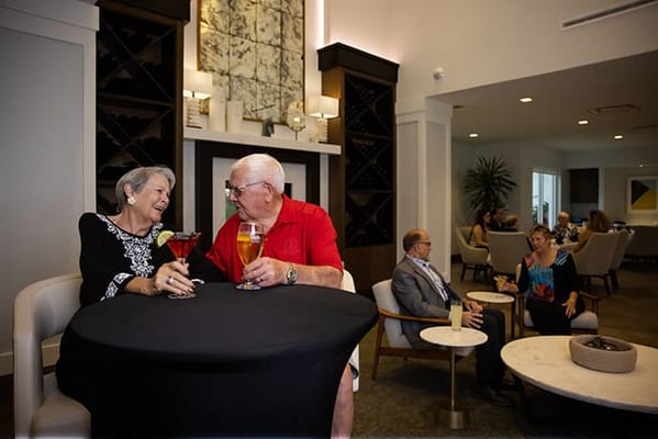 Residents enjoying drinks in a stylish common area