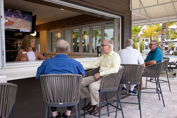 Residents socializing at an outdoor bar area