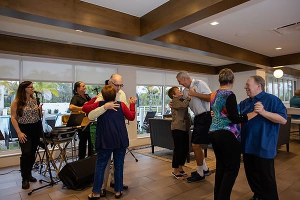 Residents enjoying a dance activity in a common area