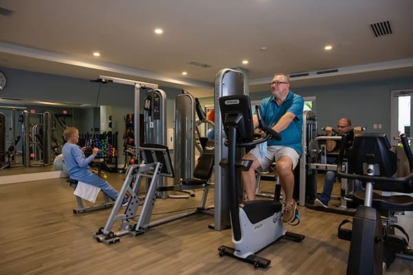 Residents engaging in exercise in a fitness room
