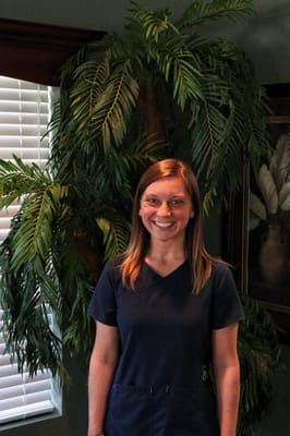 Staff member smiling in a facility interior