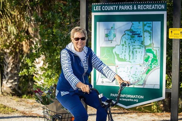 Senior woman enjoying a bike ride in a park