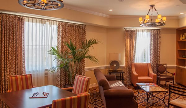 Bright common area with seating and large windows