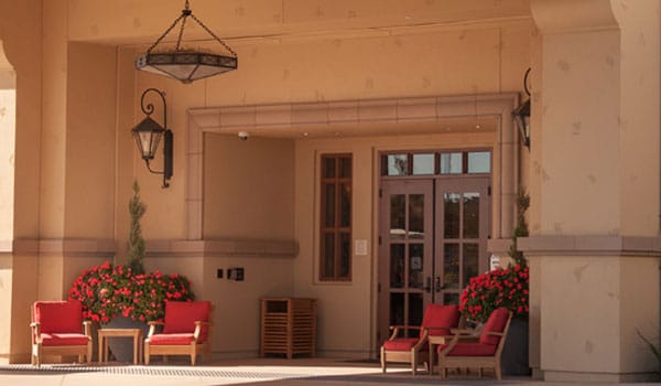 Entrance of Creekview Assisted Living with seating and flowers
