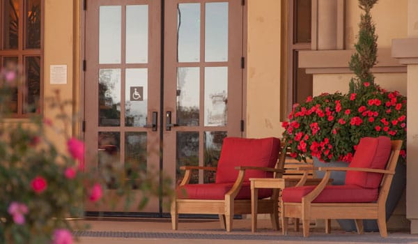 Outdoor seating area with flowers near the entrance