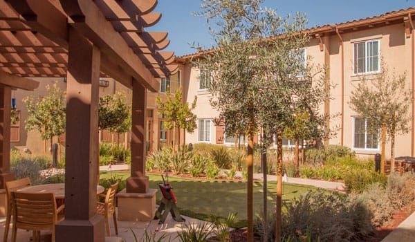 View of a landscaped outdoor space with seating and gardens