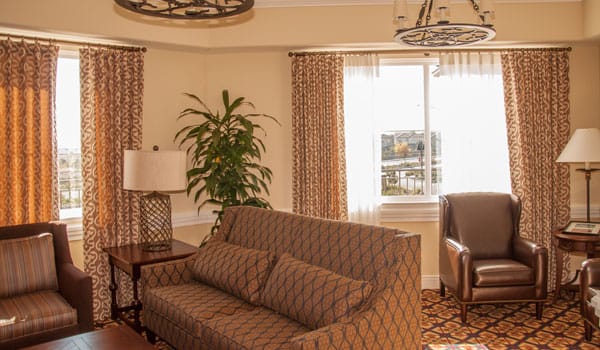 Bright interior common area with seating and curtains