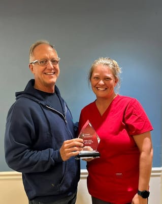 Staff member receiving an award in a facility setting
