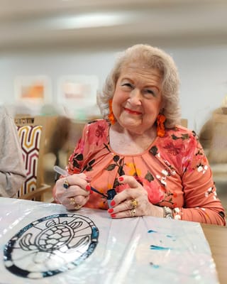 Resident painting in an activity room
