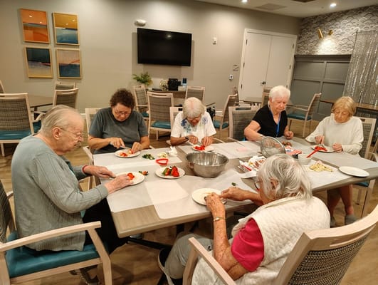 Residents engaged in a cooking activity in a common area