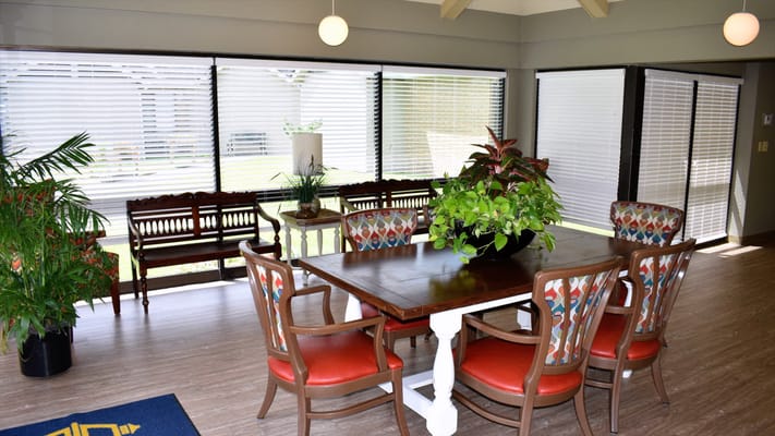 Bright common area with dining table and chairs
