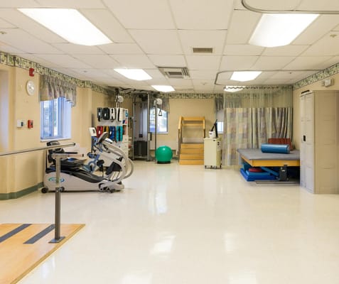 Therapy room with exercise equipment and treatment areas