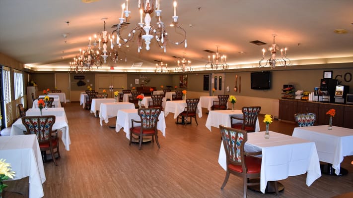Bright dining room with tables set for meals