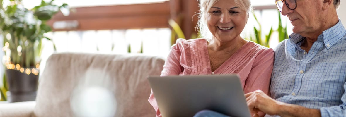 Two residents enjoying time together with a laptop