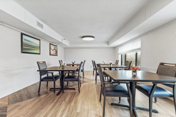 Bright dining room with tables and flowers