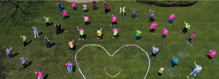 Residents participating in a heart-themed outdoor event