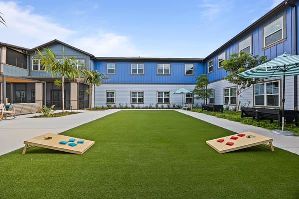 Outdoor courtyard with cornhole game setup