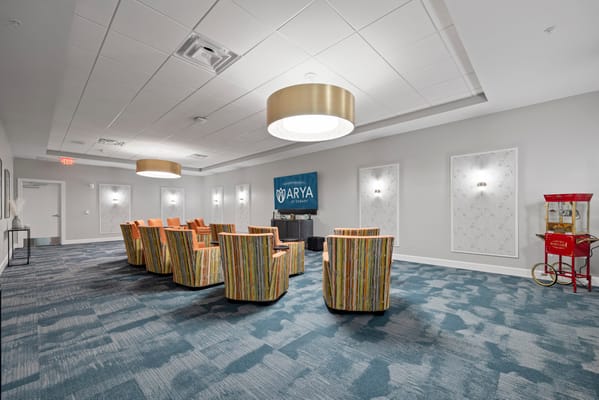 Common area with colorful chairs and facility logo