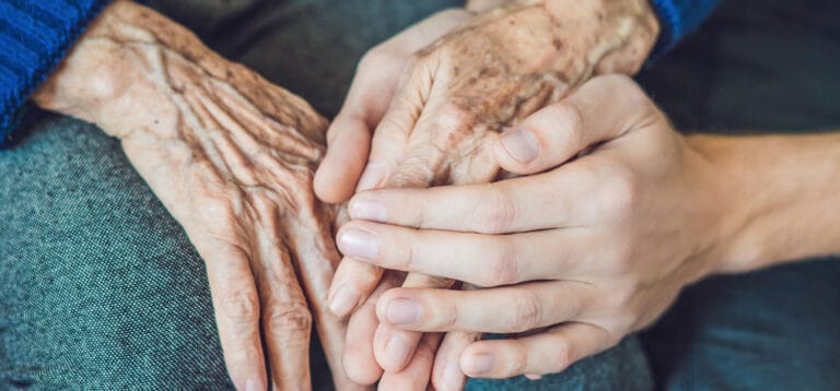 Close-up of elderly hands held together